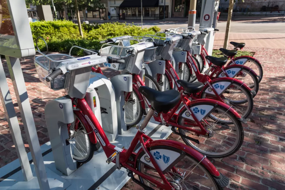 Docked BCycle bike share station in Houston with red bikes